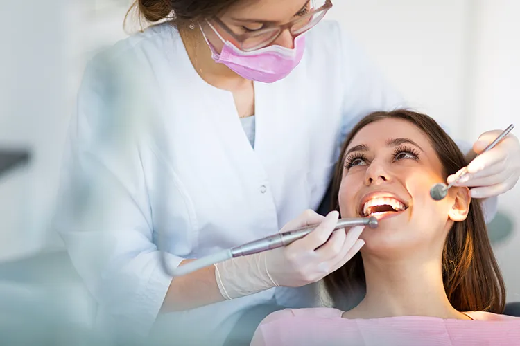 Dentist inspecting a patients teeth - Harmony Family Dentistry in Vancouver WA