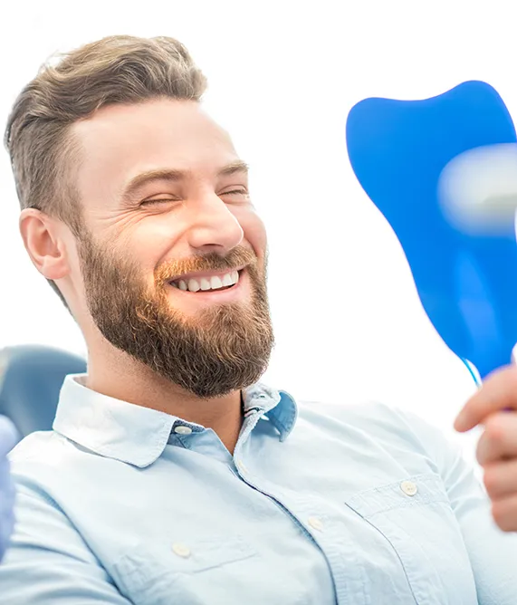 Dental patient with hand mirror smiling - Harmony Family Dentistry in Vancouver WA