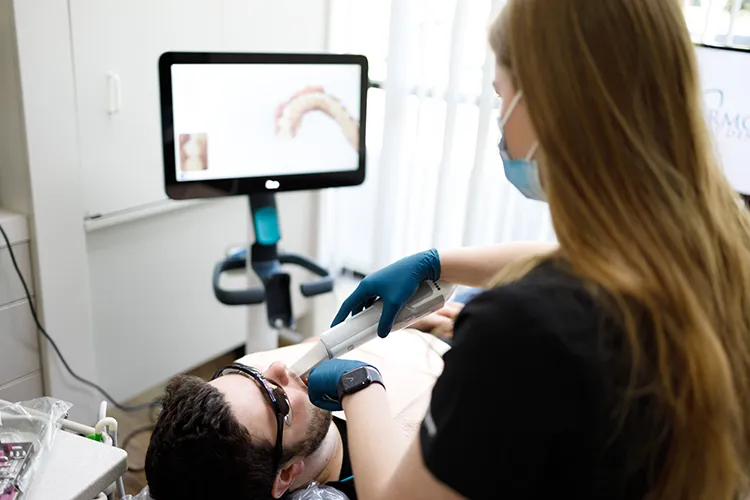 Dental technician examining a patient's teeth - Harmony Family Dentistry in Vancouver WA