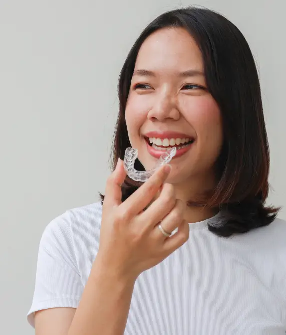 Patient holding a pair of invisalign aligners - Harmony Family Dentistry in Vancouver WA