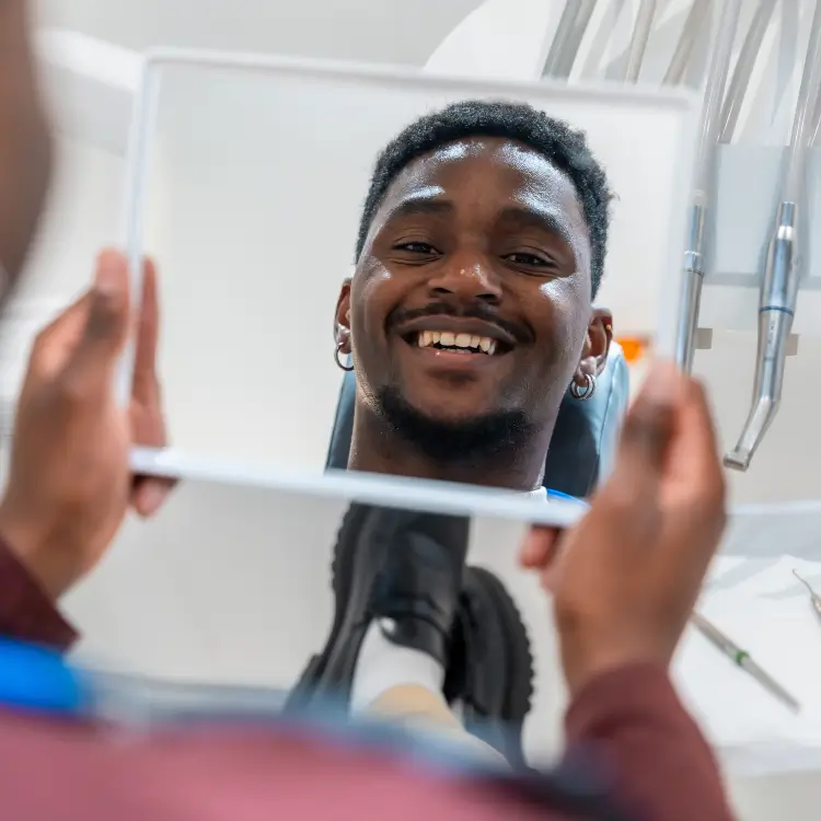 Dental patient smiling while looking into a mirror - Harmony Family Dentistry in Vancouver WA